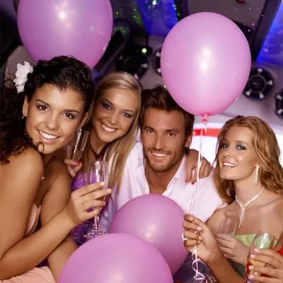 Group of friends celebrating a birthday inside a limo.